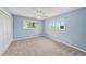 Cozy bedroom with carpet flooring, a ceiling fan, and two windows for natural light at 2309 Cypress Walk Way, Ruskin, FL 33570