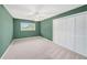 Bright bedroom features carpet flooring, a window, and closet space at 2309 Cypress Walk Way, Ruskin, FL 33570