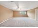Spacious bedroom with neutral carpet, ceiling fan, and a bright window view at 2309 Cypress Walk Way, Ruskin, FL 33570
