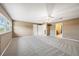 Spacious bedroom with neutral carpet flooring, ceiling fan, and two closets at 2309 Cypress Walk Way, Ruskin, FL 33570