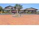 Stunning two-story home featuring brick accents, mature trees, fountain, and a beautiful brick driveway at 2309 Cypress Walk Way, Ruskin, FL 33570
