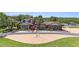 Beautiful two-story home with manicured front lawn, mature trees, brick accents, fountain and brick driveway at 2309 Cypress Walk Way, Ruskin, FL 33570