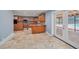 Open kitchen boasts granite counters, center island, tile flooring, and access to the screened pool at 2309 Cypress Walk Way, Ruskin, FL 33570