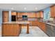 Well-equipped kitchen features stainless appliances, granite counters, tiled backsplash, and an island at 2309 Cypress Walk Way, Ruskin, FL 33570