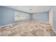 Spacious living area with light blue walls, large windows offering natural light, and marble floors at 2309 Cypress Walk Way, Ruskin, FL 33570