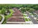 Aerial view of real estate property in a gated community with a lake and landscaping at 26338 Whirlaway Ter, Wesley Chapel, FL 33544