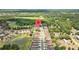 Aerial view of neighborhood with tree coverage and several ponds in a lakeside community at 26338 Whirlaway Ter, Wesley Chapel, FL 33544
