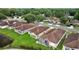 Overhead view of the house in a beautiful neighborhood with mature landscaping at 26338 Whirlaway Ter, Wesley Chapel, FL 33544