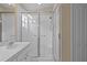Bright bathroom features neutral walls, sink with mirror, and shower with glass doors at 26338 Whirlaway Ter, Wesley Chapel, FL 33544
