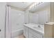 Bathroom features a shower and tub combo and white vanity at 26338 Whirlaway Ter, Wesley Chapel, FL 33544