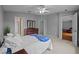Bright bedroom with neutral walls, carpet, ceiling fan, closet, and ensuite bathroom at 26338 Whirlaway Ter, Wesley Chapel, FL 33544
