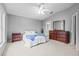 Bright bedroom features neutral walls, carpet, ceiling fan and ensuite bathroom at 26338 Whirlaway Ter, Wesley Chapel, FL 33544