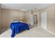 Bedroom with carpet floors, blue bed and bathroom entrance at 26338 Whirlaway Ter, Wesley Chapel, FL 33544