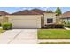 Charming single-story home with a two-car garage, well-maintained lawn, and manicured landscaping at 26338 Whirlaway Ter, Wesley Chapel, FL 33544
