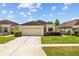 Beautiful single-Gathering home featuring a manicured lawn, two-car garage, and inviting curb appeal at 26338 Whirlaway Ter, Wesley Chapel, FL 33544