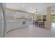 Open kitchen features white cabinets, tile floors and eat-in nook at 26338 Whirlaway Ter, Wesley Chapel, FL 33544