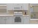 Close up of white range in kitchen with microwave and a window at 26338 Whirlaway Ter, Wesley Chapel, FL 33544