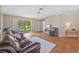 Cozy living room with a fireplace, hardwood floors, and sliding glass doors to the outdoor patio at 26338 Whirlaway Ter, Wesley Chapel, FL 33544