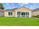 Bright sunroom with floor-to-ceiling windows overlooking lush green lawn at 26338 Whirlaway Ter, Wesley Chapel, FL 33544
