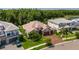 A stunning aerial view showcases this brick paver driveway and a well-landscaped yard with a stone elevation at 29118 Picana Ln, Wesley Chapel, FL 33543