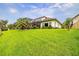 Expansive backyard featuring lush green grass and a screened enclosure, perfect for outdoor relaxation at 29118 Picana Ln, Wesley Chapel, FL 33543