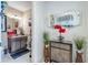 Bathroom featuring a single vanity, cabinets, granite countertop, red flowers and a decorated mirror at 29118 Picana Ln, Wesley Chapel, FL 33543