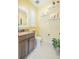 Well-lit half bath featuring a granite countertop vanity, shuttered window, and neutral walls at 29118 Picana Ln, Wesley Chapel, FL 33543