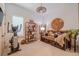 Bright bedroom area featuring an exercise bike, daybed, bookshelves, and decorative wall art at 29118 Picana Ln, Wesley Chapel, FL 33543