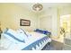 Bedroom with a fan, bed with decorative pillows, and view to the hallway at 29118 Picana Ln, Wesley Chapel, FL 33543