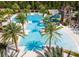 Large community pool with a water slide, palm trees, and plenty of lounge chairs for relaxation at 29118 Picana Ln, Wesley Chapel, FL 33543