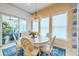 Charming dining area with elegant chandelier and access to outdoor space at 29118 Picana Ln, Wesley Chapel, FL 33543