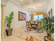 Elegant dining room featuring tray ceilings, modern light fixture and comfortable seating at 29118 Picana Ln, Wesley Chapel, FL 33543
