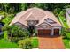 Stunning home with a two-car garage, brick-paved driveway, tile roof, and beautifully manicured landscaping at 29118 Picana Ln, Wesley Chapel, FL 33543