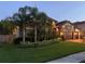 Elegant stone home featuring lush landscaping and a two-car garage with a paver driveway at 29118 Picana Ln, Wesley Chapel, FL 33543