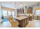 Bright, open kitchen with a large island, pendant lighting, and a dining area at 29118 Picana Ln, Wesley Chapel, FL 33543