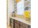 Kitchen area features a wine fridge, custom cabinetry, and modern countertops at 29118 Picana Ln, Wesley Chapel, FL 33543
