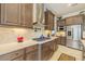 Updated kitchen featuring stone countertops, stainless steel appliances, and ample cabinet space at 29118 Picana Ln, Wesley Chapel, FL 33543