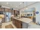 Modern kitchen featuring stainless steel appliances, a large island, and an open layout at 29118 Picana Ln, Wesley Chapel, FL 33543