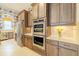 Gourmet kitchen with stainless steel appliances, double oven, and stylish cabinetry at 29118 Picana Ln, Wesley Chapel, FL 33543