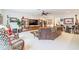 Spacious living room boasting stylish furniture, a flat-screen TV, decorative shelving, and modern decor at 29118 Picana Ln, Wesley Chapel, FL 33543