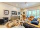 Bright living room with modern furniture, a large television, and outdoor access at 29118 Picana Ln, Wesley Chapel, FL 33543