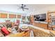 Spacious living room featuring a large TV, comfortable seating, and custom shelving at 29118 Picana Ln, Wesley Chapel, FL 33543