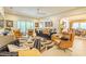 Spacious living room with plush seating, large windows, and an open layout at 29118 Picana Ln, Wesley Chapel, FL 33543