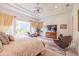 Spacious main bedroom boasts a tray ceiling, large windows, and a chic area rug at 29118 Picana Ln, Wesley Chapel, FL 33543