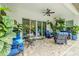 Spacious covered patio with stylish furniture, ceiling fan, and serene backyard views at 29118 Picana Ln, Wesley Chapel, FL 33543