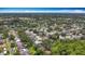 Wide aerial view showing a large suburban community filled with lush greenery and well-kept homes at 2973 Spring Oak Ct, Palm Harbor, FL 34684