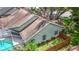 Aerial view of a home featuring a screened-in pool area, well-maintained lawn, and wooden privacy fence at 2973 Spring Oak Ct, Palm Harbor, FL 34684