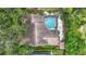 Aerial view of a charming home featuring a screened pool and meticulously landscaped backyard at 2973 Spring Oak Ct, Palm Harbor, FL 34684