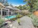 A backyard showcasing a pool, privacy fence, and well-kept landscaping at 2973 Spring Oak Ct, Palm Harbor, FL 34684