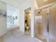 Bathroom with a glass shower, transom window, and bright vanity lighting at 2973 Spring Oak Ct, Palm Harbor, FL 34684